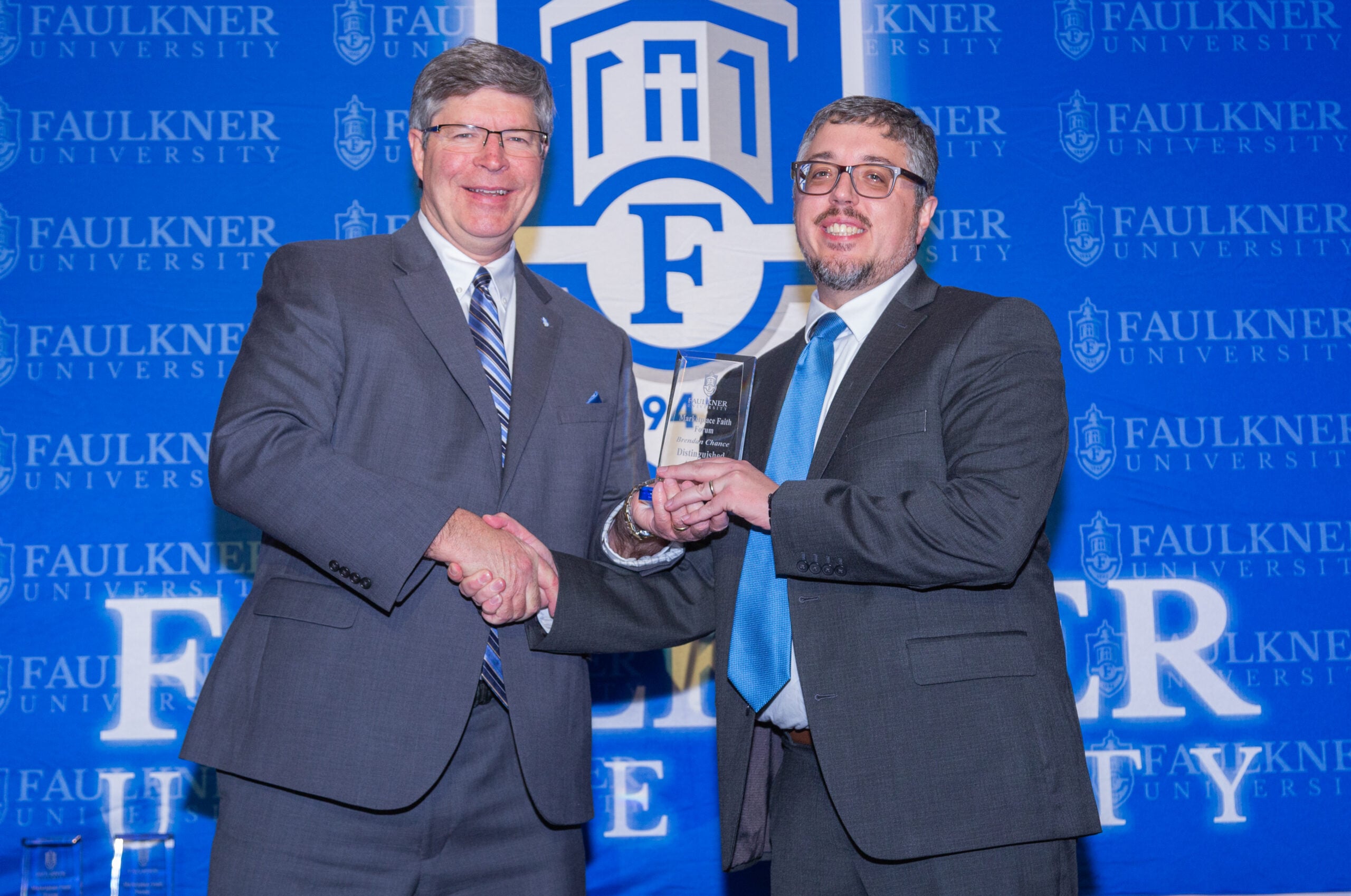 l-r President Mitch Henry presents the Distinguished Alumnus Award to Brendan Chance.
