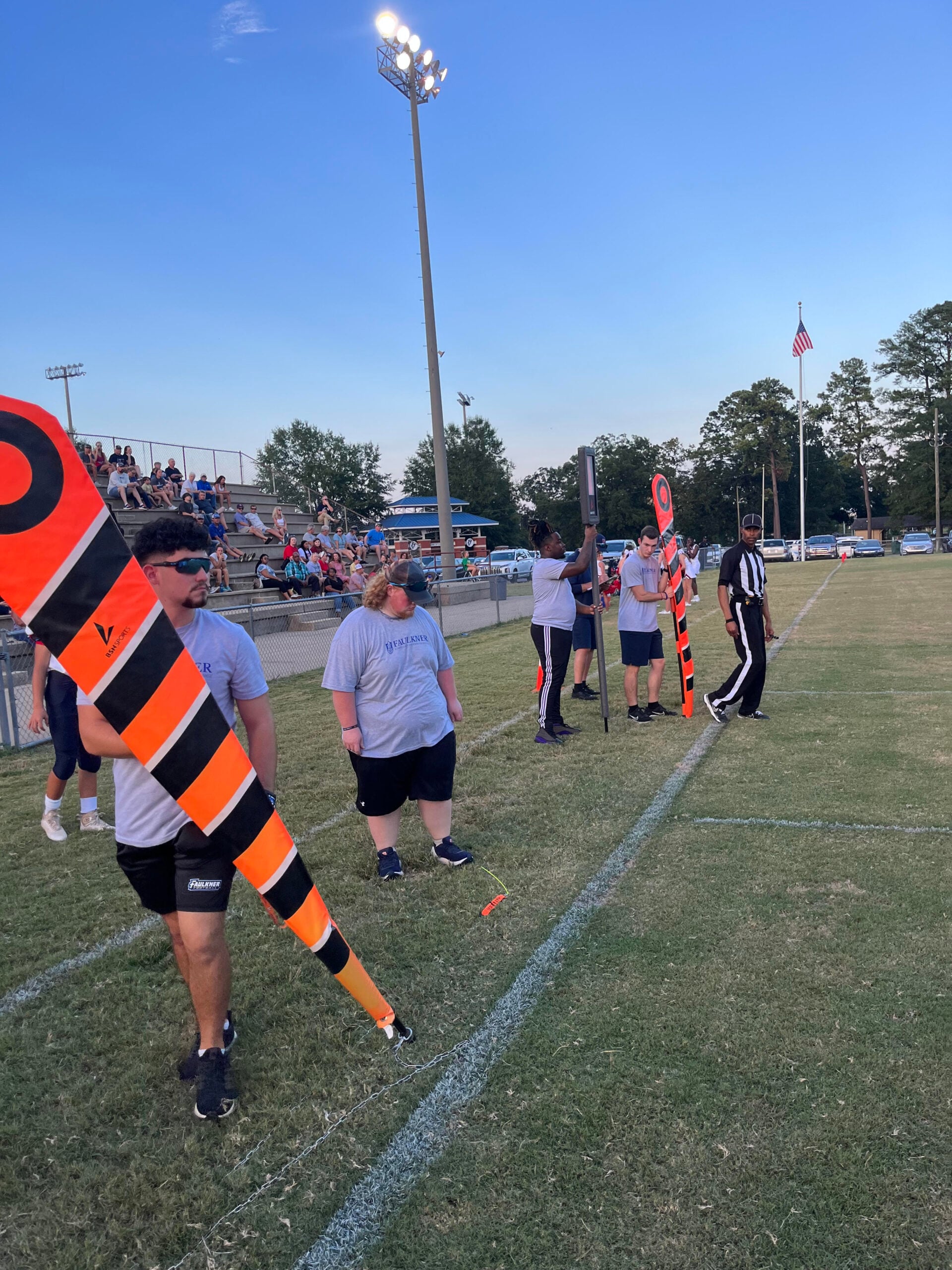 l-r Santos Sanchez, Bryce Hicks, Ja'Veon Kynard, and Nicholas Butts train with the chain crew at an ACA middle school football game. 