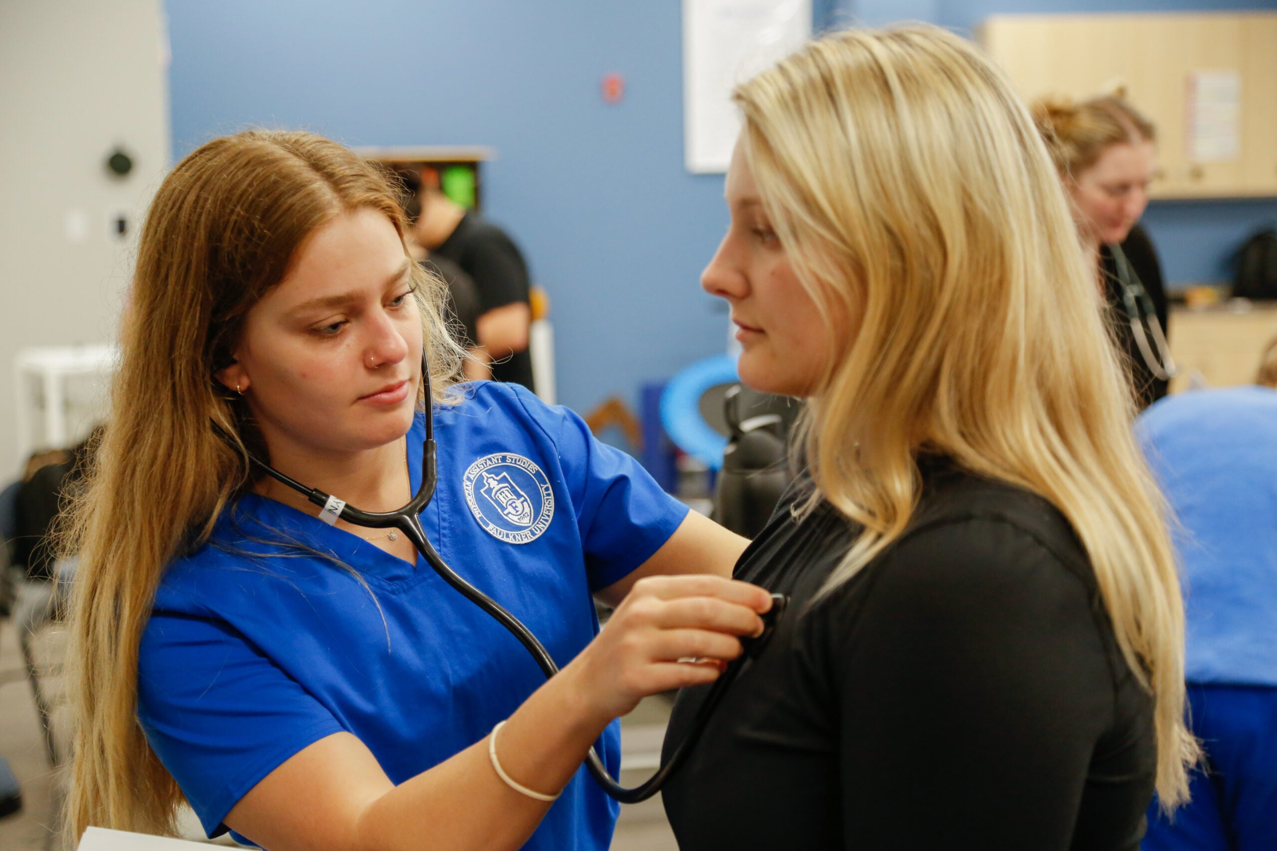 PA Students listening to heartbeat on patient